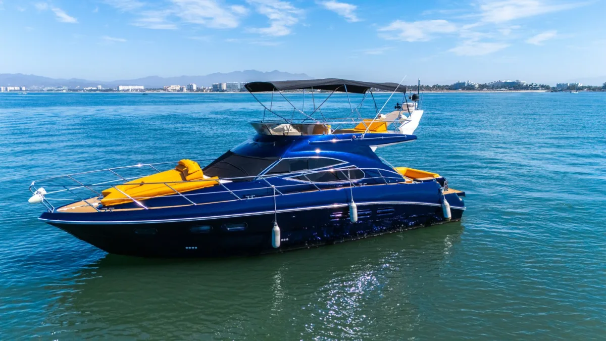 The blue-hulled 45 ft Baltra yacht cruising off Nuevo Vallarta with the hotel zone behind