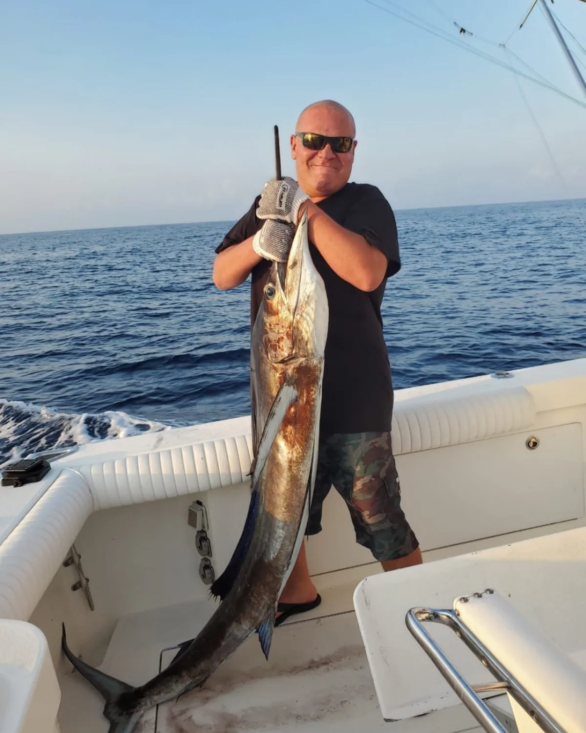 Angler holding up a billfish caught aboard the Cabo 35 sportfisher off Puerto Vallarta