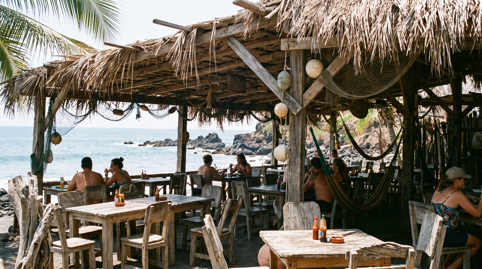 Sandy cove beach reached by water taxi near Puerto Vallarta with jungle hillside behind it